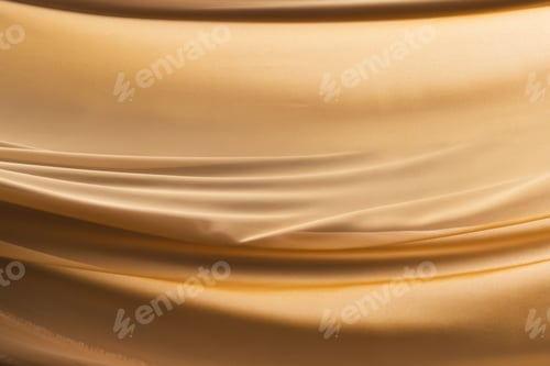 Preview: Close up of gold shiny silk fabric with copy space background