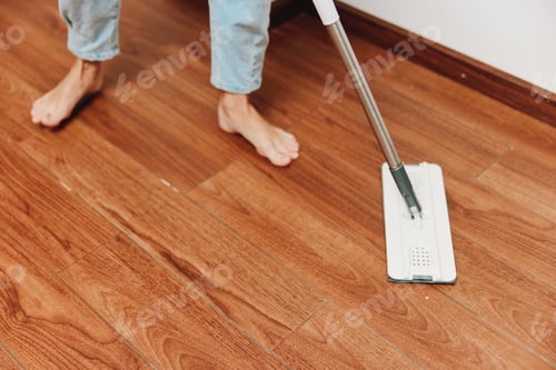 Preview: Person cleaning hardwood floor with wooden mop