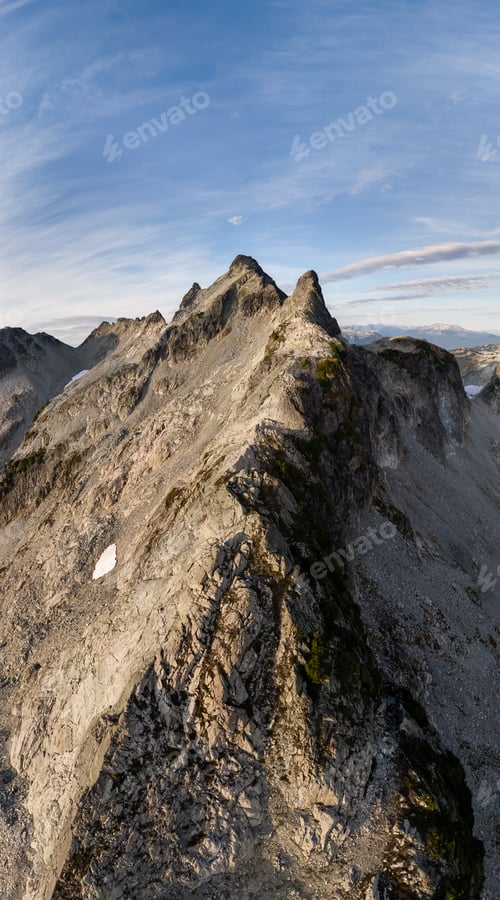 Preview: Majestic Alpine Ridge Over Rugged Rocky Peak Under Clear Sky in British Columbia, Canada