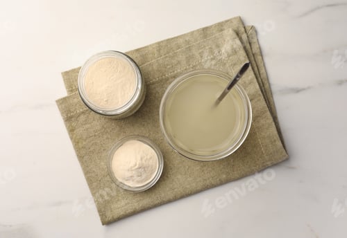 Preview: Agar-agar jelly and powder on white marble table, top view