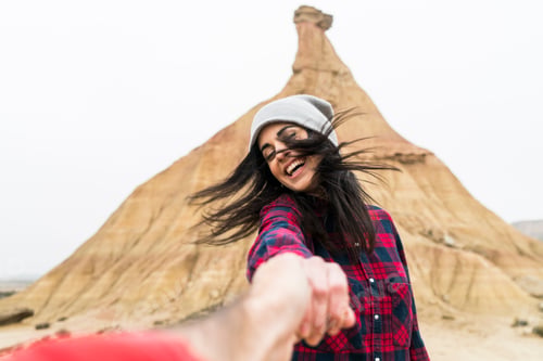 Preview: Spain, Navarra, Bardenas Reales, moving young woman holding hand of her boyfriend