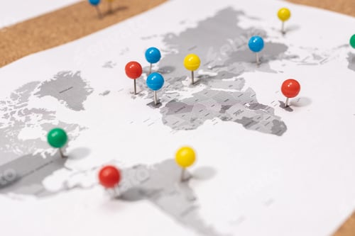 Preview: Close up of Pushpins on world map on Corkboard