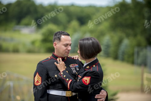Preview: Shallow focus shot of a military couple hugging