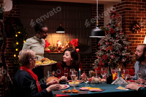 Preview: Cheerful people at festive dinner