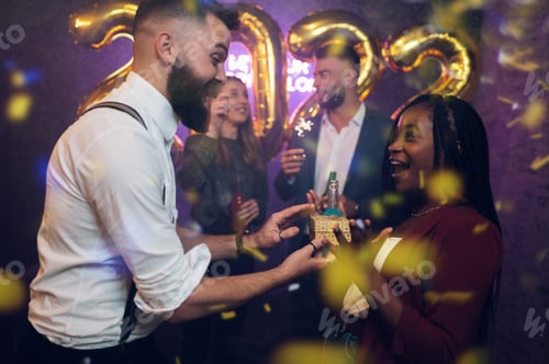 Visualização: Casal lindo e feliz celebra a véspera de Ano Novo e trocando presentes