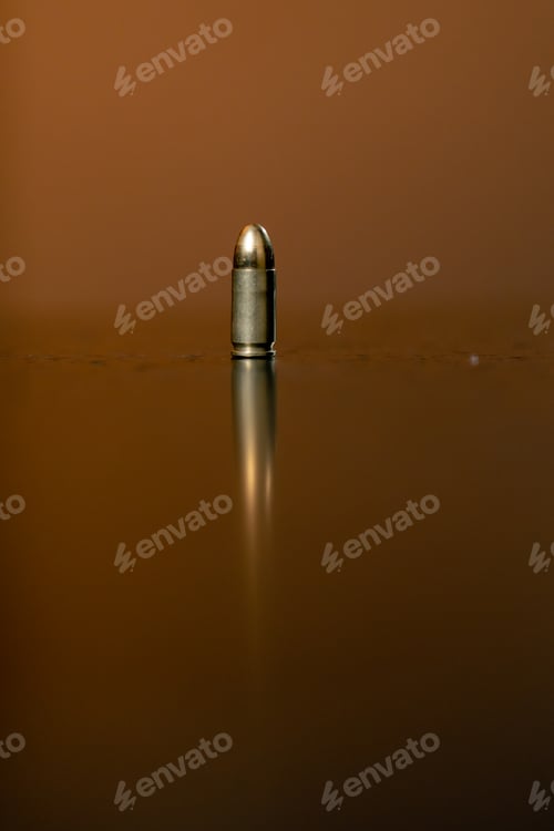 Preview: in a professional shooting range there is a ninth-caliber bullet on a black table introductory