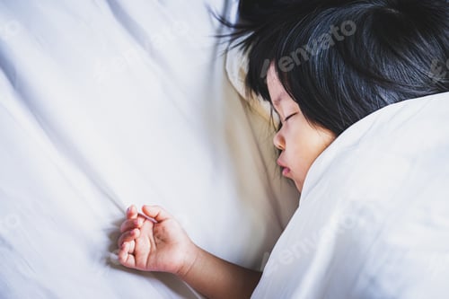 Preview: Top view child girl sleeping on the white soft bed on bedroom. Kid resting a nap.