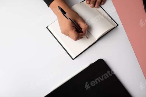 Preview: Hand writing in a blank notebook