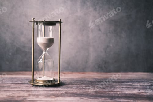 Preview: hourglass on table, sand flowing through the bulb of sandglass
