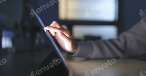 Preview: Working on tablet computer at night