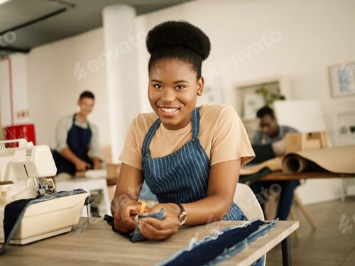 Preview: Happy designer cutting fabric. African american tailor cutting denim. Fashion designer cutting deni