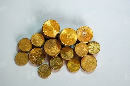 Preview: Top view of stacks of golden coins on a white background