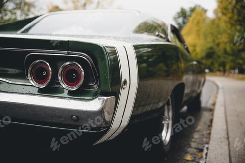 Preview: Closeup shot of a green muscle car on a blurred background