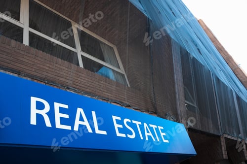 Preview: Sign with the word Real State in a building in rehabilitation.
