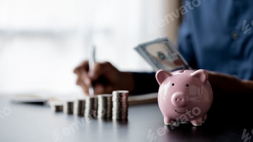 Preview: A pink piggy bank and a pile of coins are placed. Money saving.