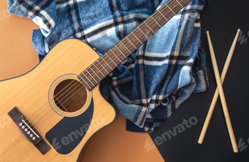Preview: Music background with guitar and drumsticks, top view.