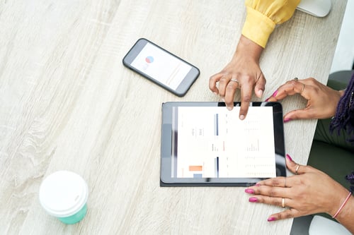 Preview: Businesswoman typing on tablet at workplace. Women working in home office hand keyboard