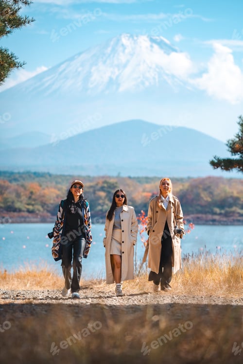 Preview: Happy tourist traveler woman or man enjoying on lake kawaguchiko with mount fuji in japan