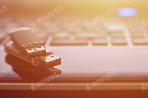 Preview: USB flash cards lying on black laptop case in front of his keyboard