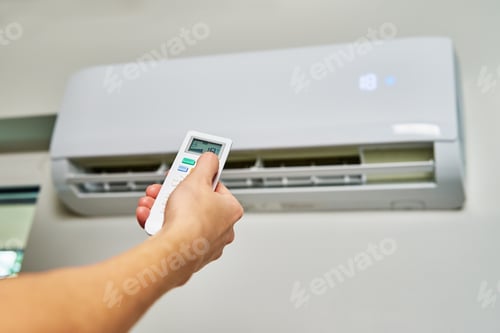 Preview: Hand adjusting temperature on air conditioner