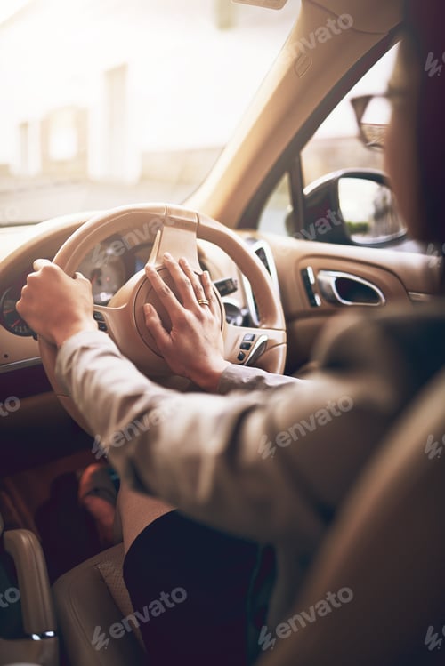 Preview: Get a move on. Shot of an unidentifiable businesswoman pressing the hooter while driving a car.