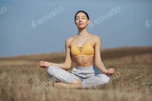 Preview: Woman Meditating Outdoors in Serene Peaceful Setting