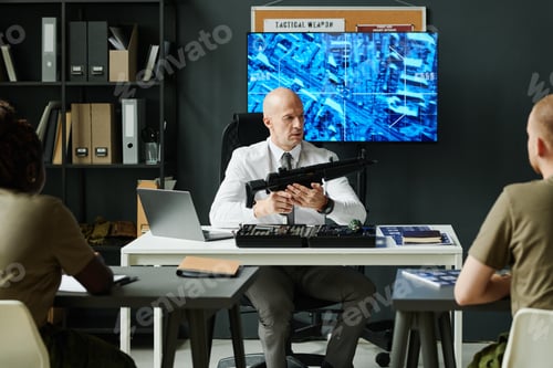 Preview: Experienced military coach holding machine gun during presentation