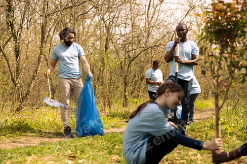 Preview: Environmental volunteers collecting rubbish and plastic waste in garbage bag