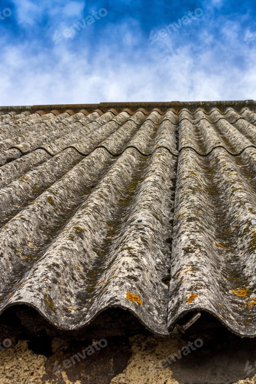 Preview: Closeup shot of roof tiles covered in rust under the the cloudy sky
