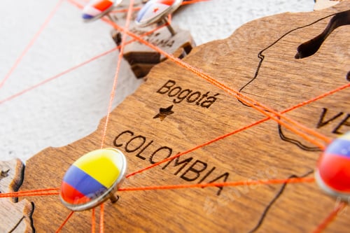 Preview: Colombia flag pins and red thread for traveling and planning trip.