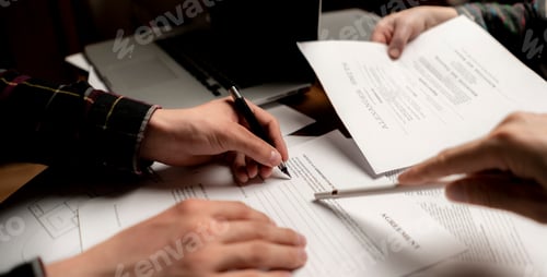 Preview: close up photo of crew of businessmen signing documents