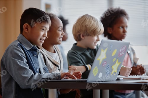 Preview: Smiling Children Using Computer in Class