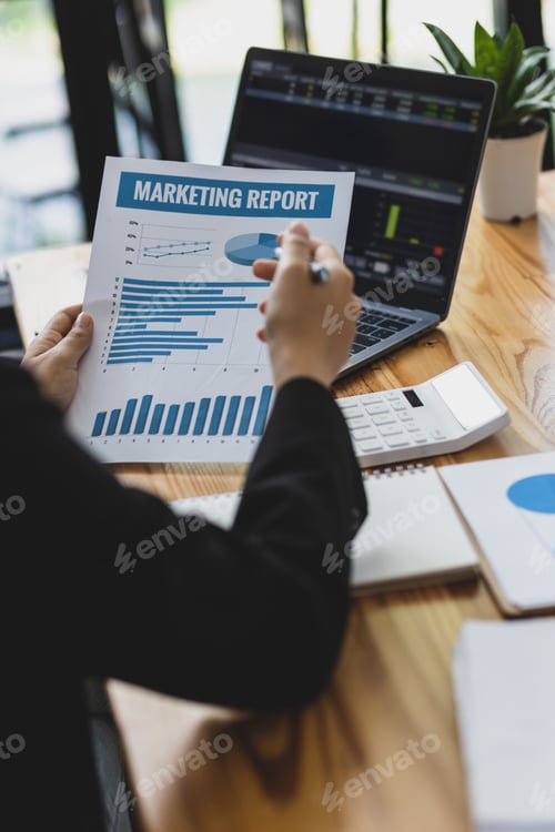 Preview: Businesswoman working paperwork, Analysis financial report document and investment chart on laptop.