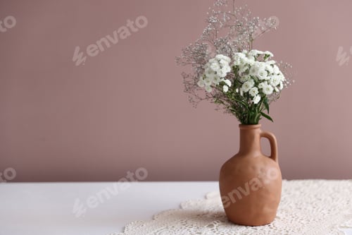 Preview: Beautiful flowers in vase on white table against pink background, space for text