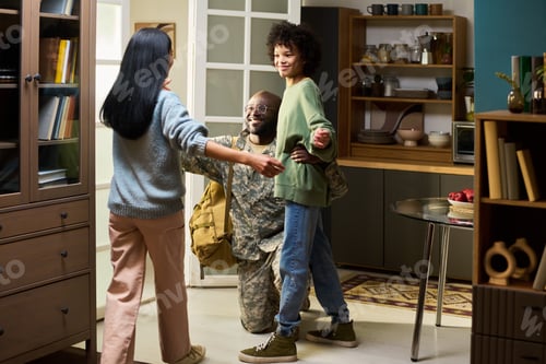 Preview: Middle Aged Black Man in Military Uniform Embracing Family Members at Home