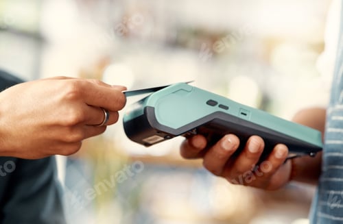 Preview: Shot of a man using a nfc machine to make a card payment at a restaurant