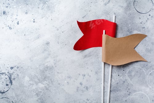 Preview: Decorative flags from craft paper on a gray old concrete background. Top view.