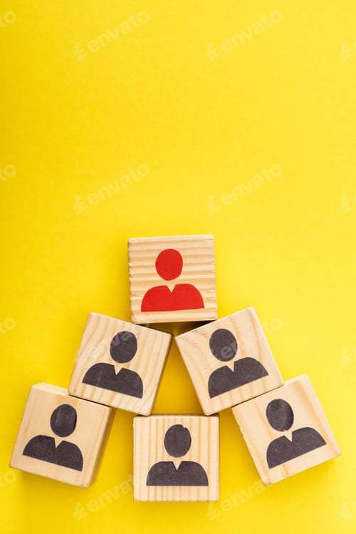 Preview: Top view of wooden cubes with red painted man among another on yellow background