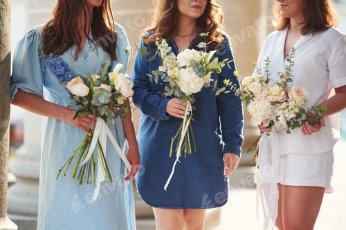 Preview: Close up view of women that are with flowers in hands