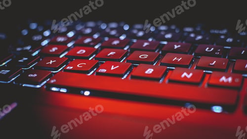 Preview: Closeup shot of a laptop keyboard under red light