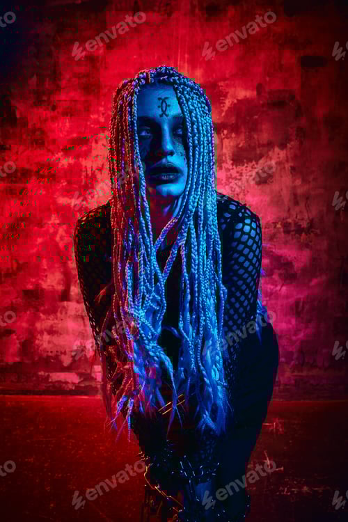 Preview: Female model in halloween outfit posing with on a red background. Gorgeous girl in clothes