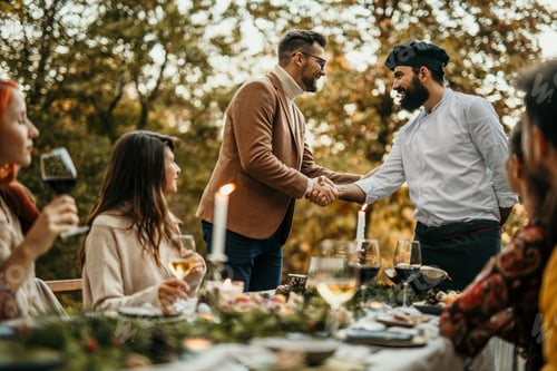 Preview: Businessman shaking hands with chef during a garden party