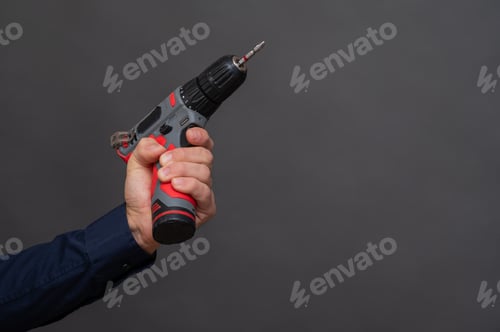 Preview: Power drill held firmly by worker hand,