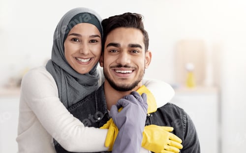 Preview: Closeup of happy middle-eastern couple cleaning kitchen