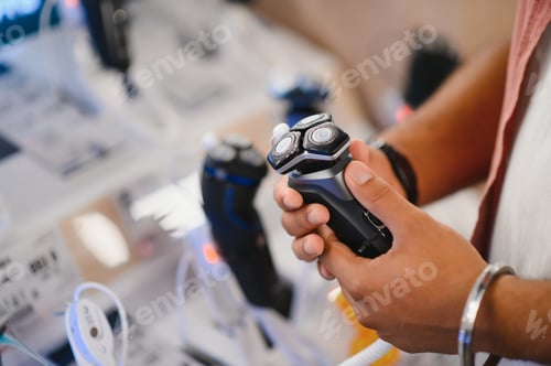 Preview: Indian Man choosing trimmer at electric store