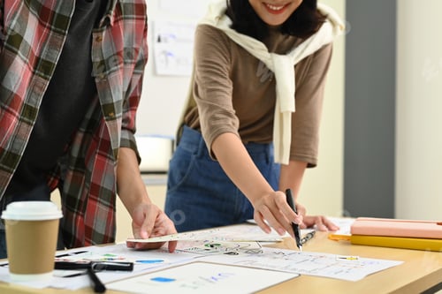 Preview: Male and female creative web designer brainstorming for design project at office.