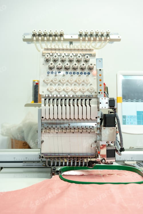 Preview: Close up of embroidery machine making patterns on textiles