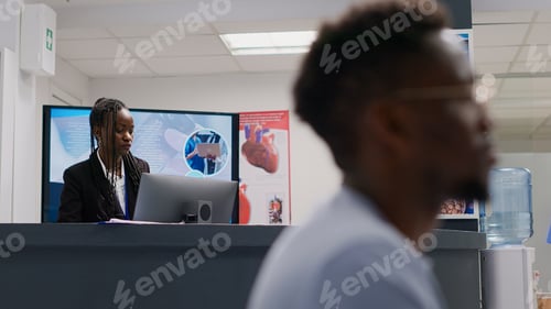 Preview: Male doctor asking receptionist about medical appointments