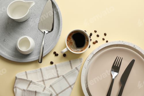 Preview: Table setting with cup of coffee on beige background, top view