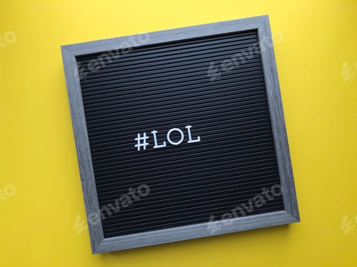 Preview: Gray letter board on yellow background with hashtag LOL